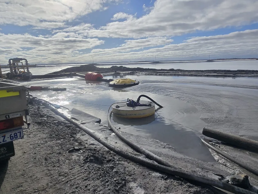 Dredging work on a tailings pond with hoses